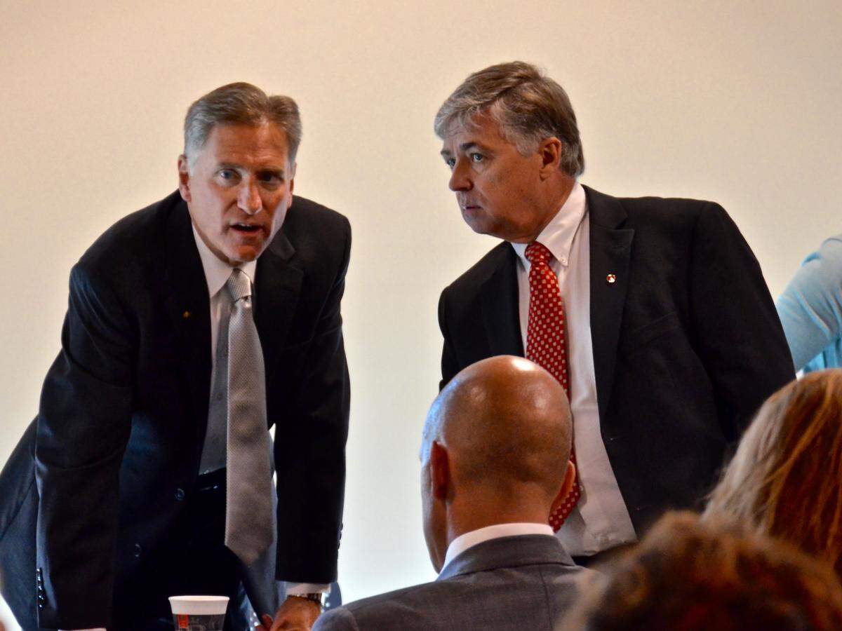 SIUE Chancellor Randy Pembrook (right) confers with SIU President Randy Dunn shortly before the trustees' board meeting to decide whether to suspend Dunn as president.
