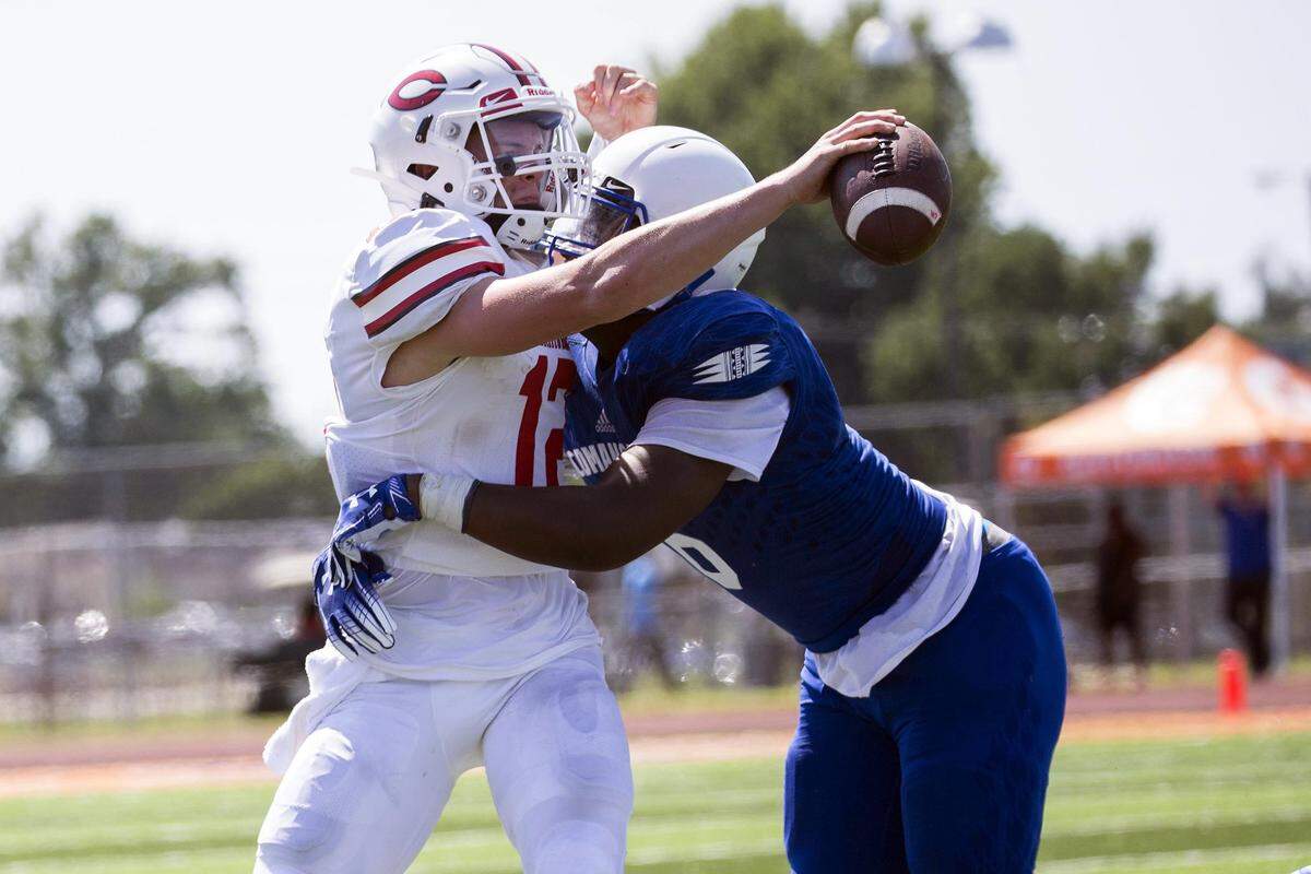 Cahokia’s Shawn Binford sacks Chaminade’s Brady Cook during a game at the Gateway Scholars Classic in East St. Louis during Week 1 of the season.