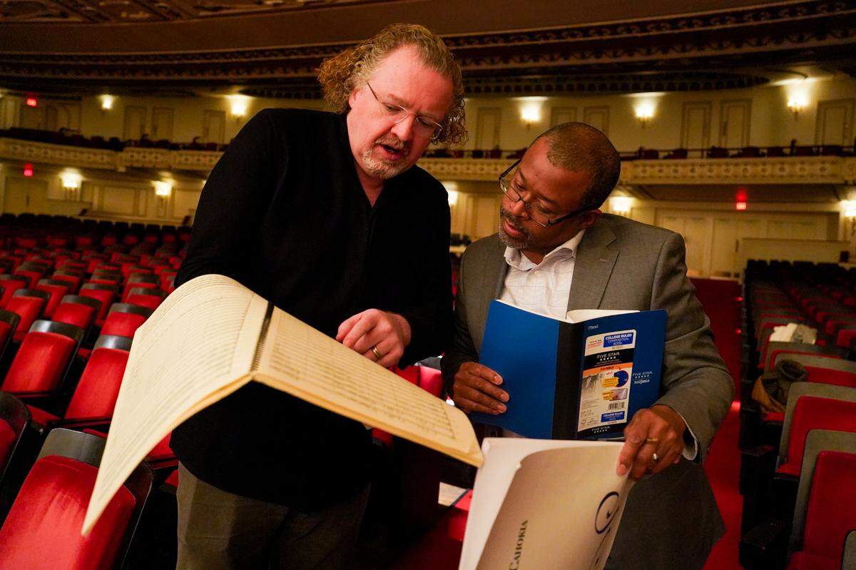 Baltimore-based composer James Lee III and St. Louis Symphonic Orchestra music director Stéphane Denève go over notes on Lee’s “Visions of Cahokia,” on Wednesday, Jan. 25, 2023, during a rehearsal ahead of the piece’s world premiere at Powell Hall in Grand Center. 