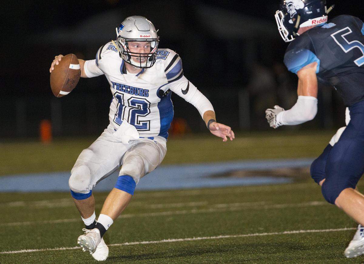 Freeburg’s Cal Clossen carries the ball during the Freeburg - Mater Dei Varsity football game Friday night in Breese.