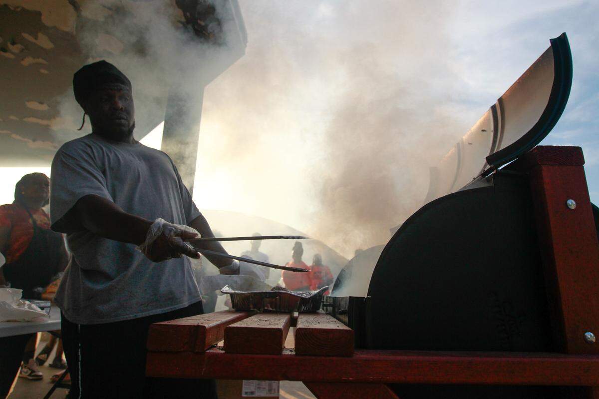 Antoine Newby runs the grill at East St. Louis’s Lincoln Park on Aug. 1, 2023 as part of the National Night Out. Newby ran the grill for over two hours in order to serve the hundreds of people who came out to give crime a “going away party.”
