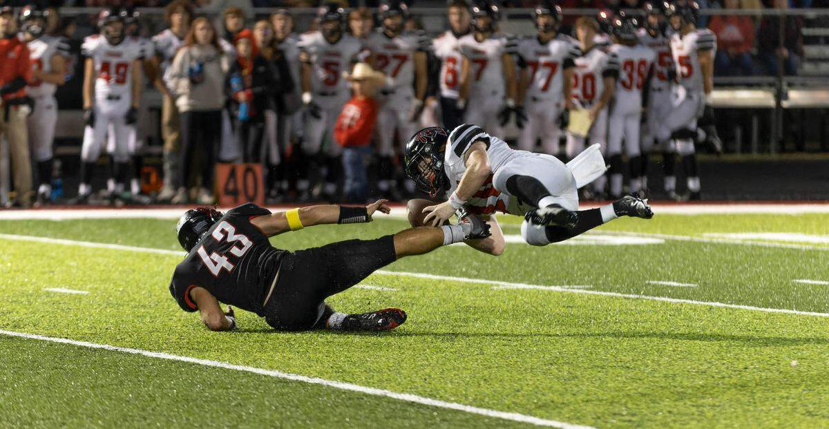 Highland Brenden Gelly (43) sacks Triad’s Isaac Ackerman during a Mississippi Valley Conference game Friday night. The Bulldogs ultimately rolled to a 35-0 triumph.