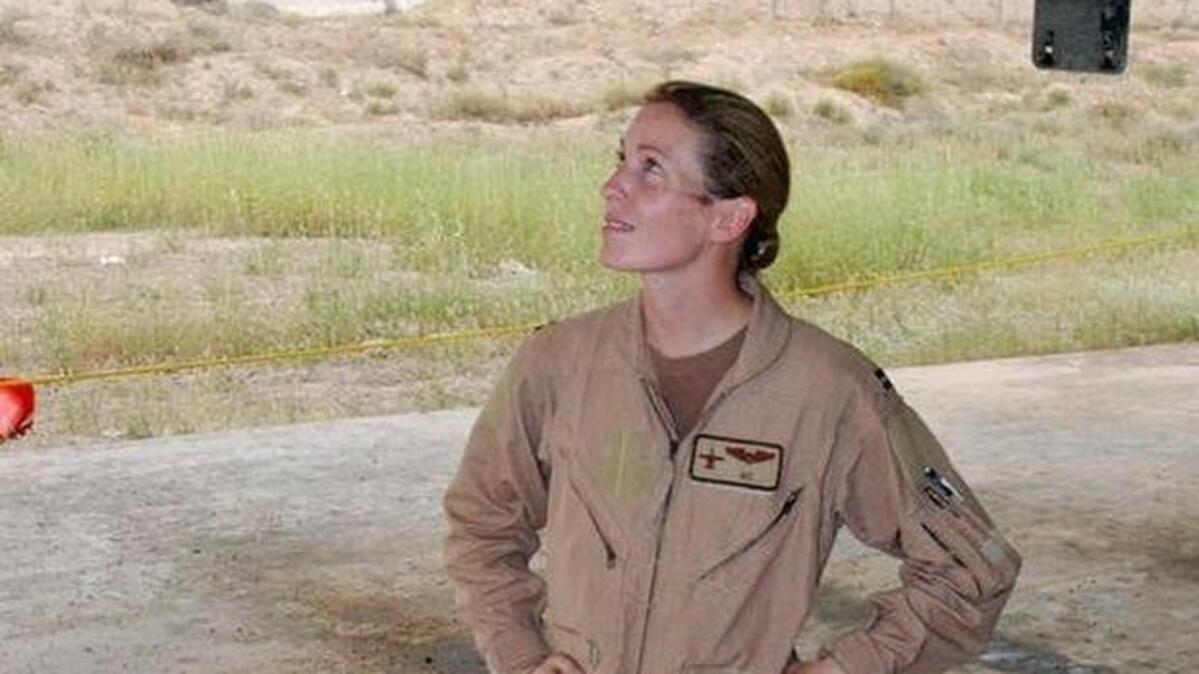 Then-Capt. Kim Campbell surveys the battle damage to her A-10 Thunderbolt II at a base in Southwest Asia. Campbell’s A-10 was hit over Baghdad during a close air support mission April 7, 2003. At the time she was deployed with the 332nd Air Expeditionary Wing.