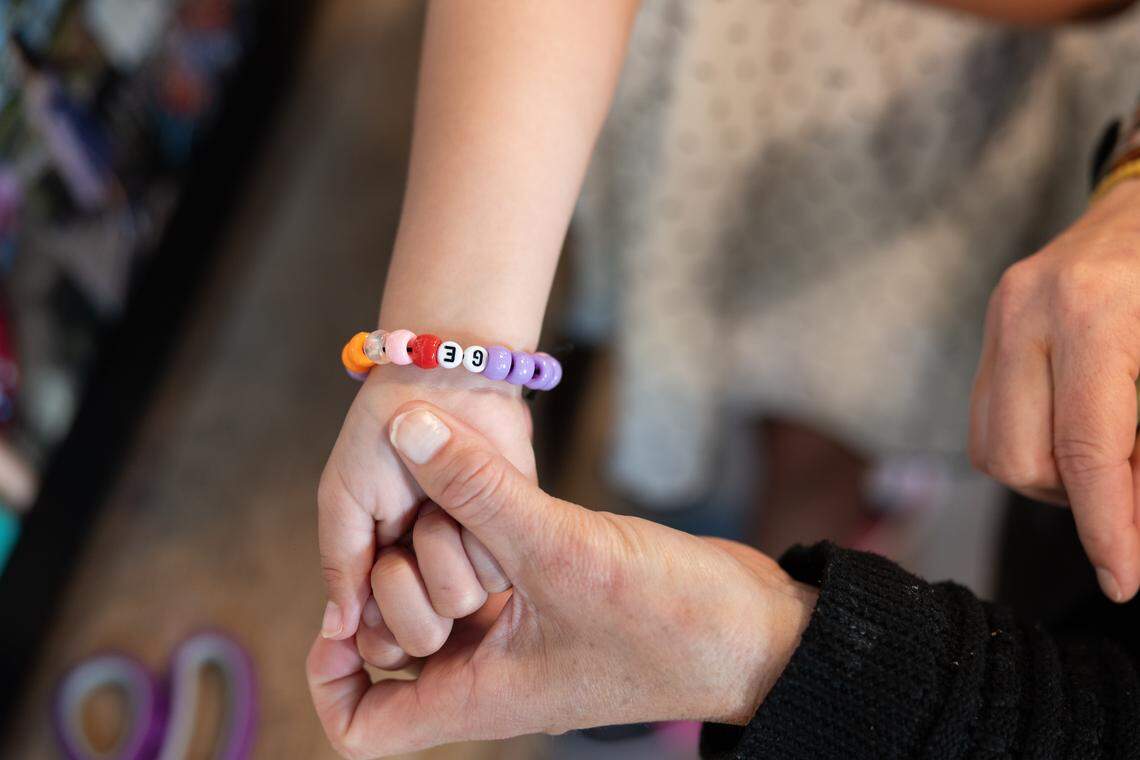 Angie Augustine shows off her daughters Grayson’s bracelet, which bares the letters “GE,” symbolizing that her and Elsie are “together.”