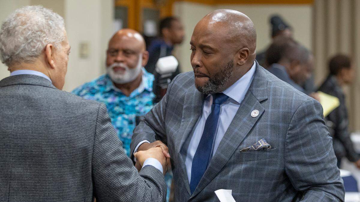 East St. Louis Mayor Robert Eastern III, shakes hands with a supporter during his official re-election fundraiser in October. Two months later, several city employees say they were fired because they wouldn’t commit their support for him. Eastern denies it.