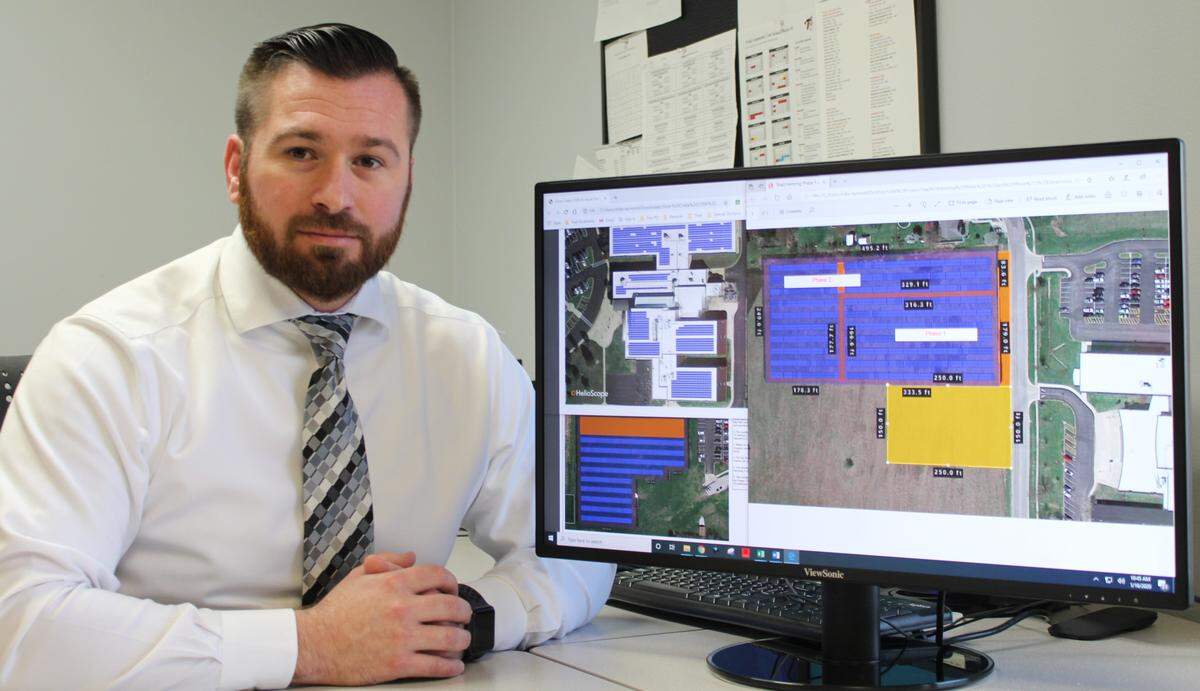 Mike Raymond, director of business and communication for Triad Community Unit School District 2, displays plans for solar projects at Henning, Silver Creek and St. Jacob schools.