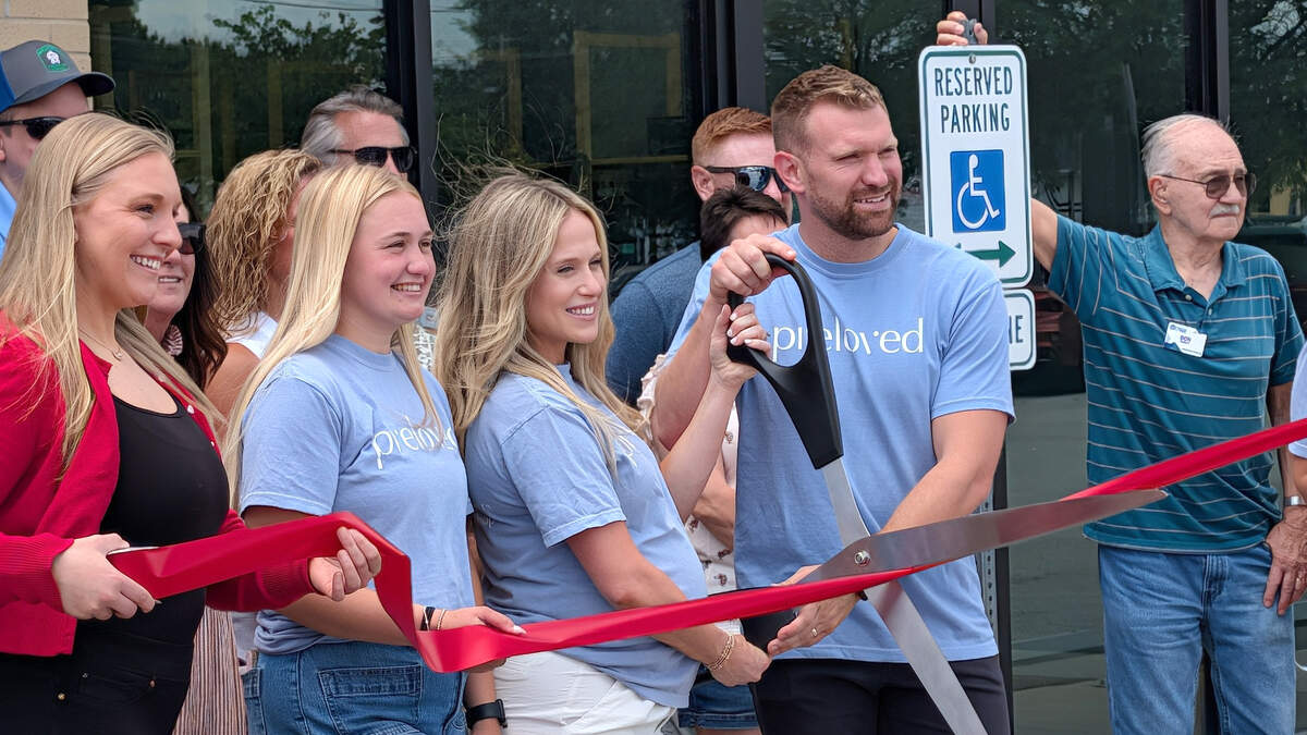 Preloved owners Savannah and Michael Romshek cut the ribbon for their new O'Fallon store.