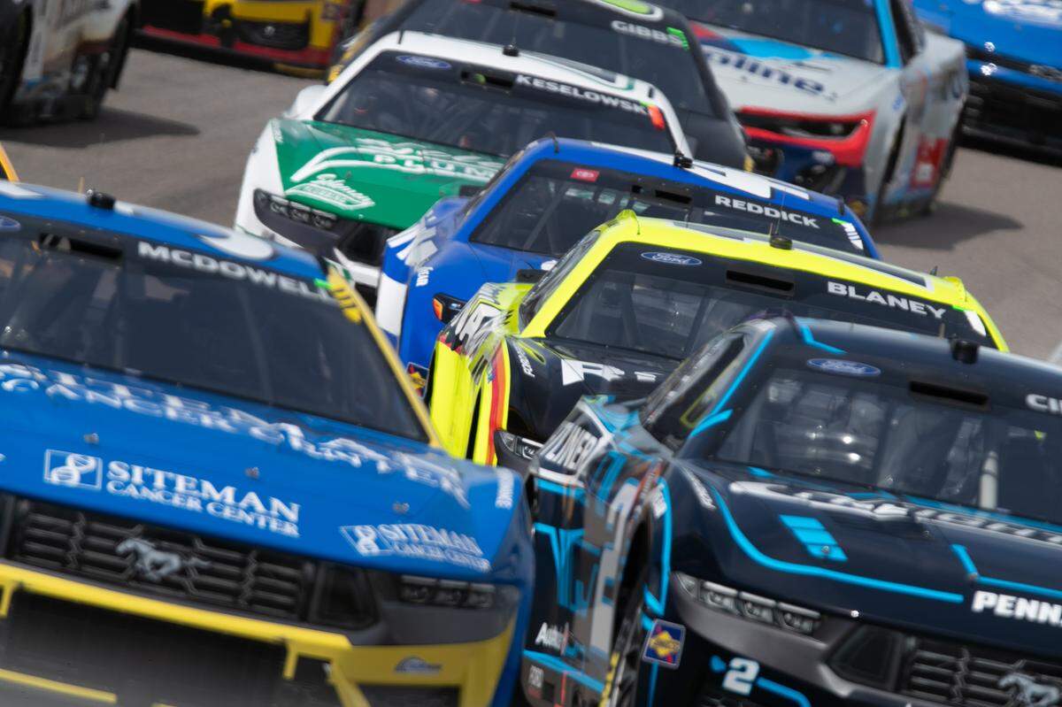 Austin Cindric (front right) fights with Michael McDowell (front left) during the Enjoy Illinois 300 Cup Race at WorldWide Technology Raceway in Madison, Ill. on June 2, 2024. Cindric would go on to win the race on the final lap in a surprise win.