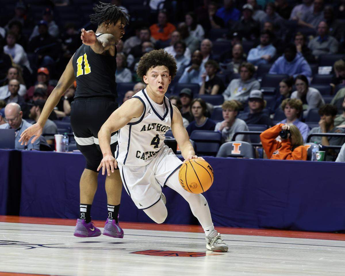 March 15, 2025 - , - Belleville Althoff’s Steven Brown drives the ball around a Dyett defender during the IHSA, 2A championship game against Chicago (Dyett) at the State Farm Center in Champaign. [Photo: Chris Johns]