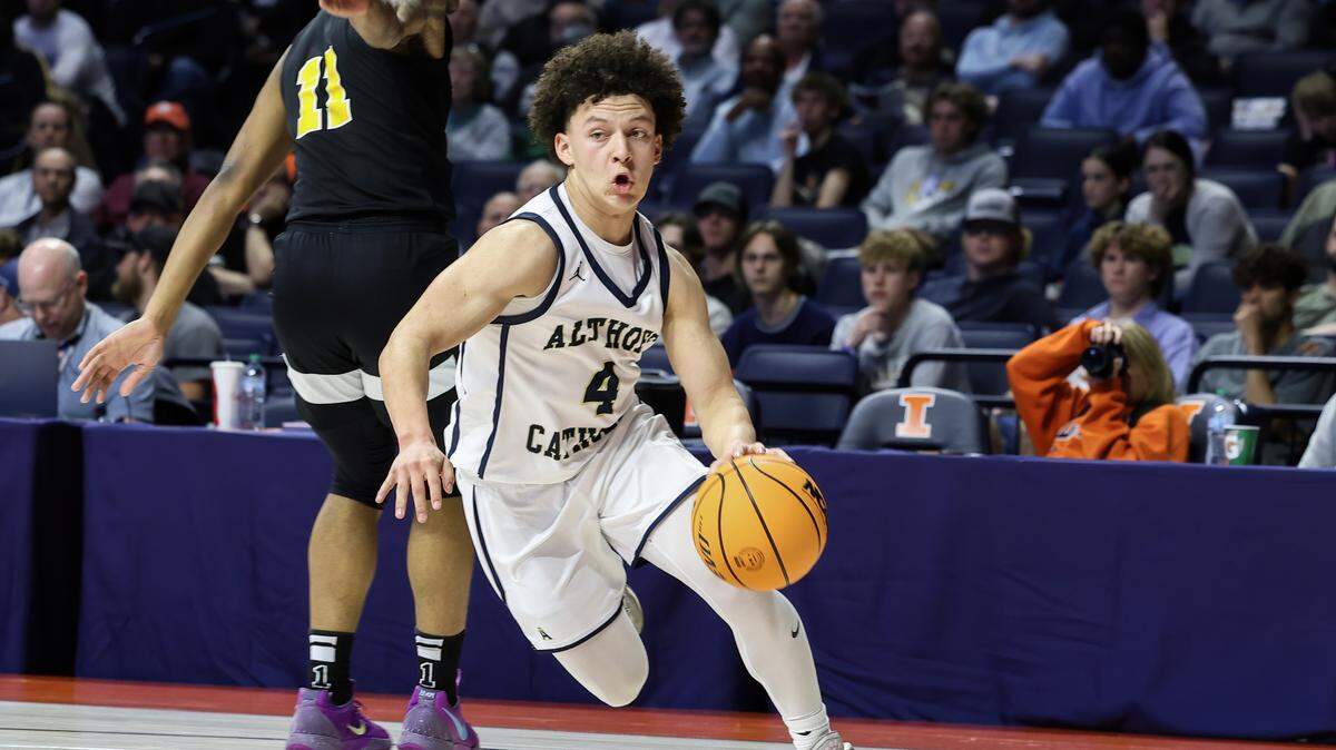 Althoff’s Steven Brown drives the ball around a Dyett defender during the IHSA Class 2A championship game against Chicago (Dyett) at the State Farm Center in Champaign. New legislation advancing through the Illinois General Assembly may allow Brown and other high school athletes participate in non-scholastic sports, even during the same season.