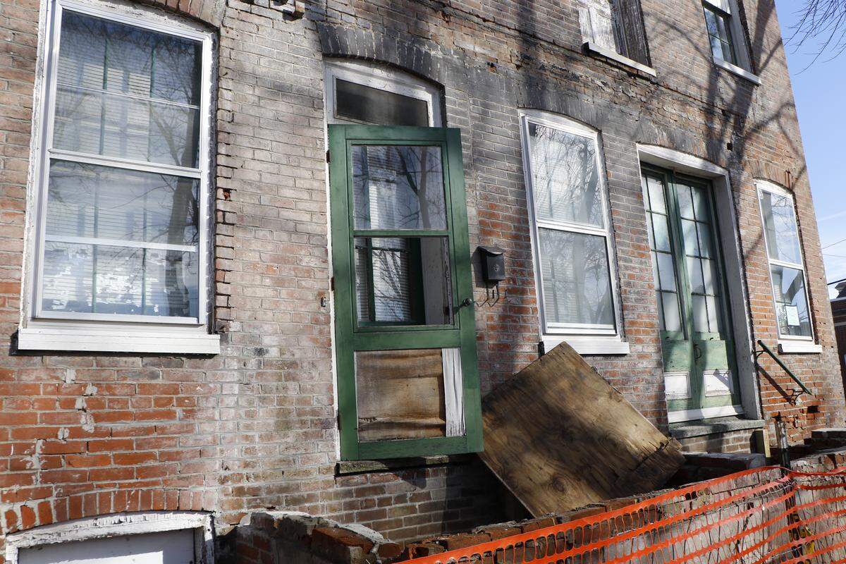 The exterior of one of the dilapidated homes in downtown Highland set to be razed in the near future. The buildings were built in the 1870s and have since been purchased by the city, which plans to build parking lots in their place.