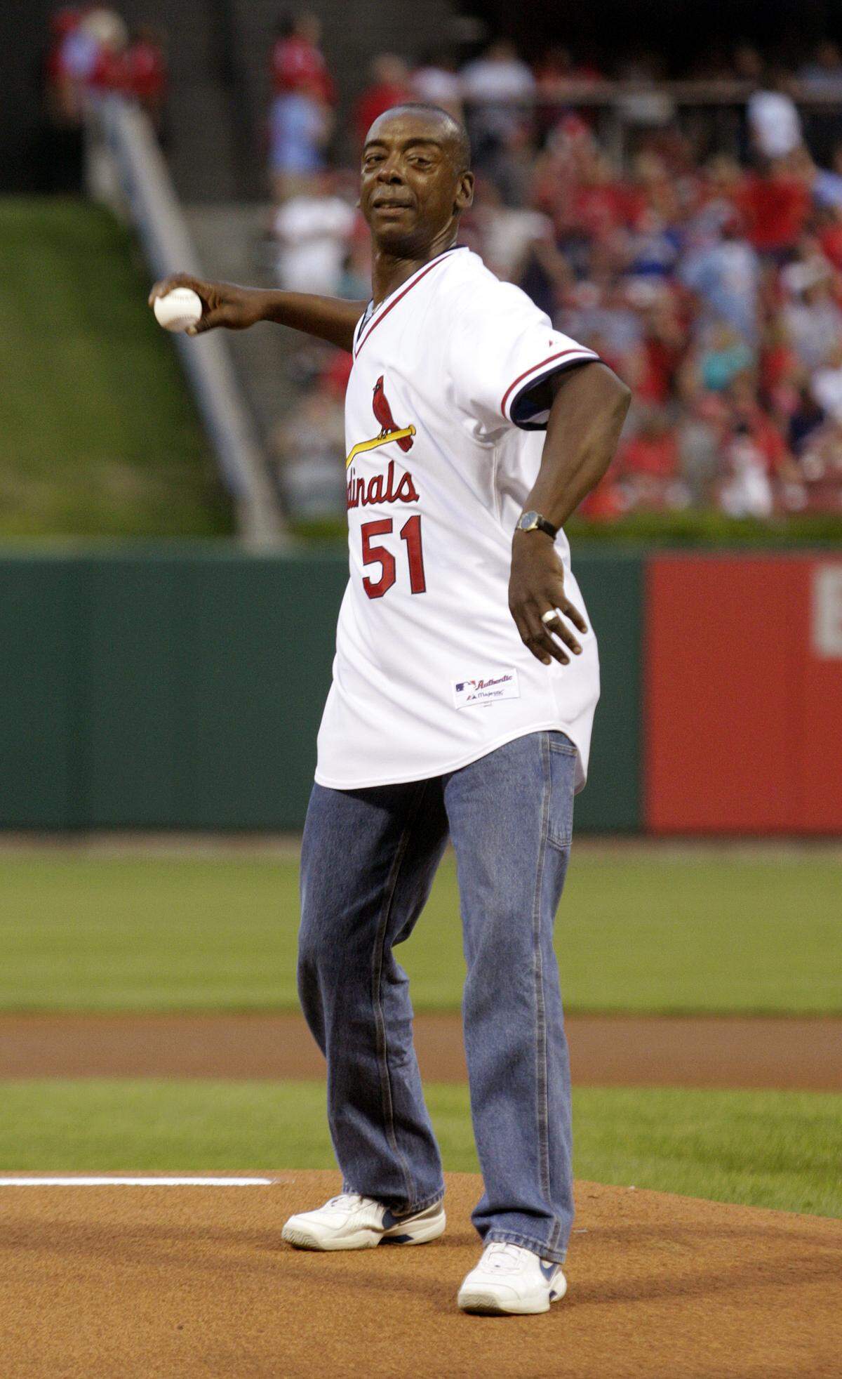 Former St. Louis Cardinals great Willie McGee throws out the first pitch before a baseball game between the Cardinals and the Pittsburgh Pirates, Friday, Aug. 26, 2011.