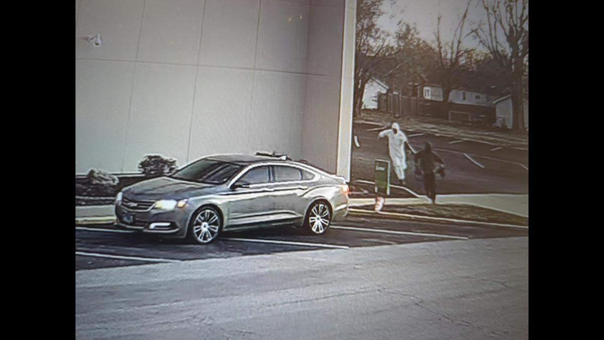 The FBI released this surveillance photo of two suspects approaching a getaway car after an armed robbery of Brink’s armored vehicle drivers at the Regions Bank in Madison on Thursday.
