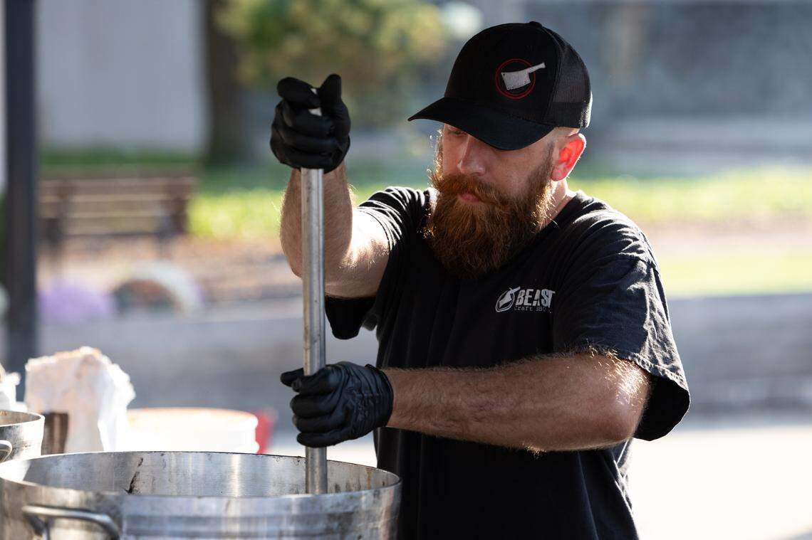 A member of Beast BBQ’s staff stirs chili during the 2024 Belleville, Ill. Chili Cook-off.