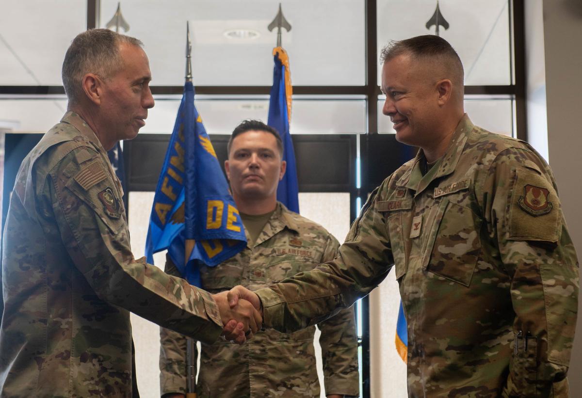 U.S. Air Force Col. James M. Clark, Air Force Installation and Mission Support Center, Detachment 9 incoming commander, assumes command after receiving the guidon from U.S. Air Force Maj. Gen. Tom Wilcox, Air Force Installation and Mission Support Center commander, during a change of command ceremony on Scott Air Force Base. AFIMSC mission is to deliver globally integrated installation and mission support to enhance warfighter readiness and lethality for America’s Air and Space Forces.