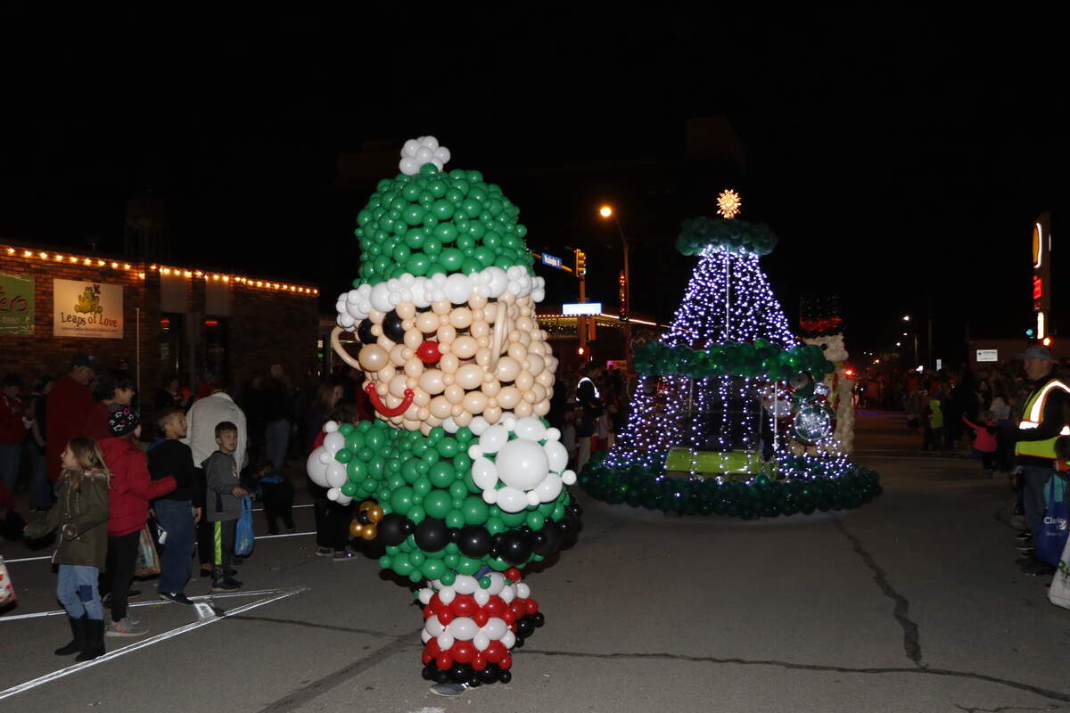 An elf made out of balloons walks in Highland’s annual Lighted Christmas Parade Saturday, Nov. 24.