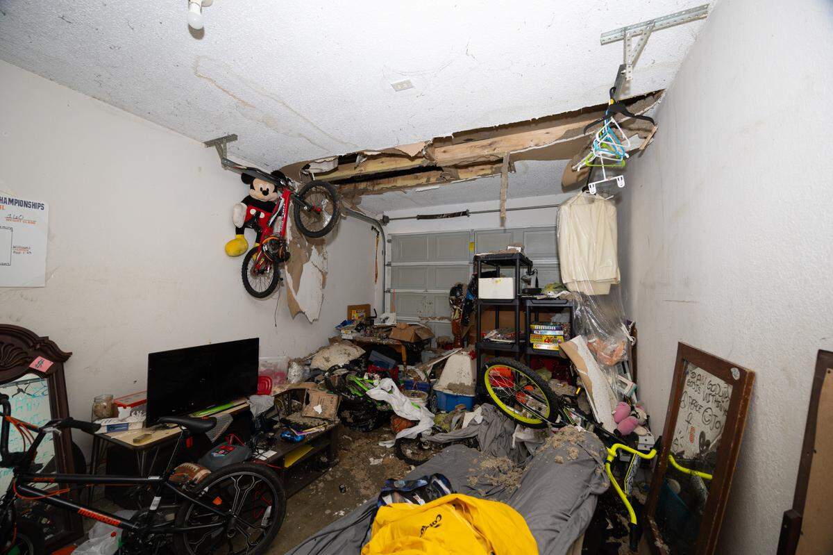 A Centreville Courts tenant’s belongings are covered in debris after the garage roof caved in. The damage has yet to be repaired.