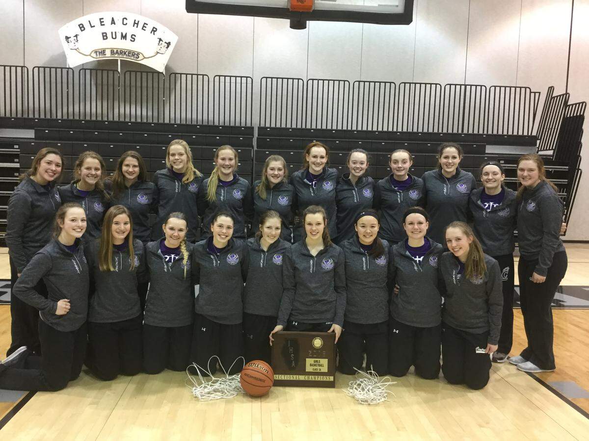 The Central girls basketball team poses with its sectional championship plaque.