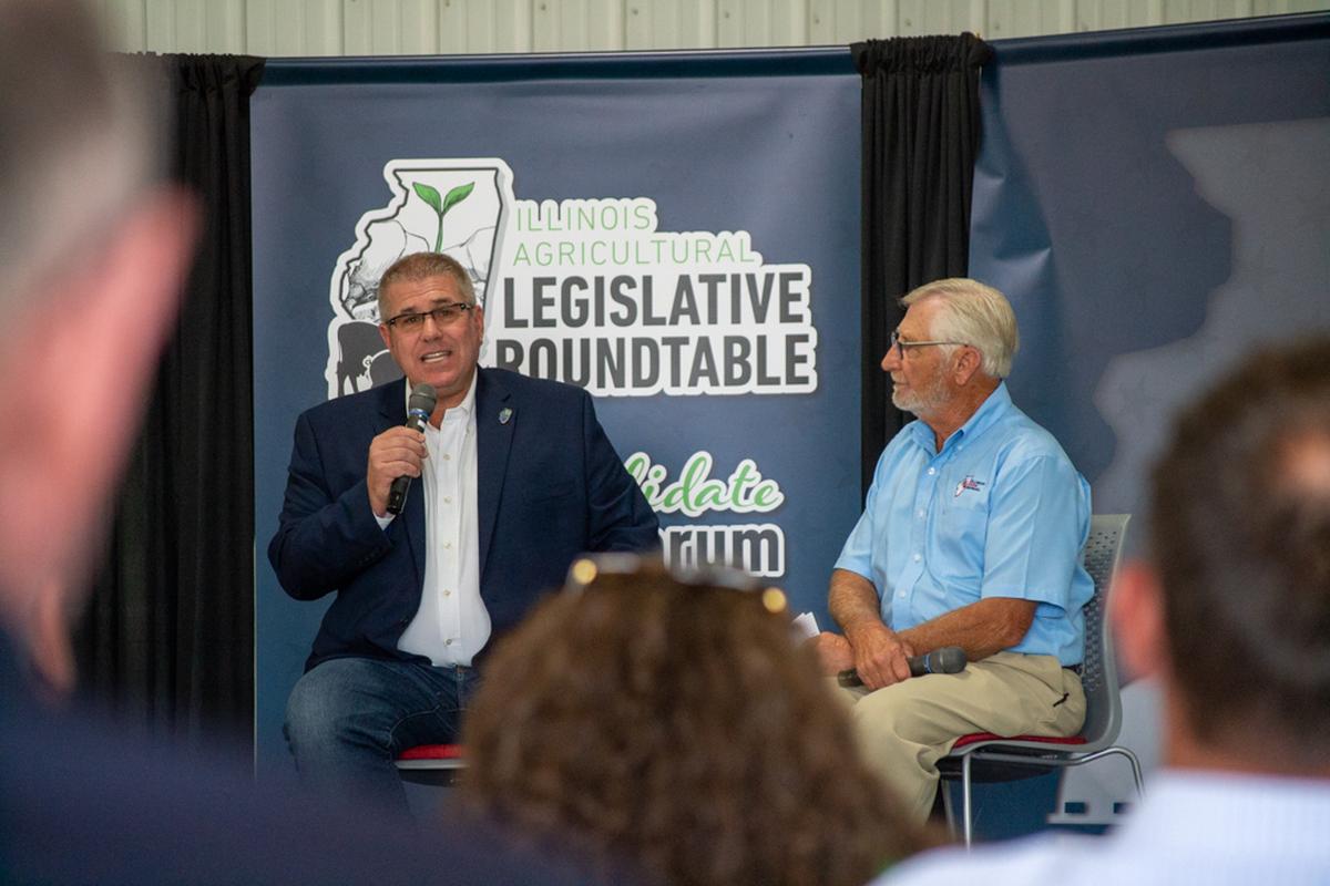 Republican gubernatorial candidate state Sen. Darren Bailey, of Xenia, talks during a legislative roundtable on a McLean County farm near Lexington. Illinois Farm Bureau President Richard Guebert Jr. (right) moderated the event.