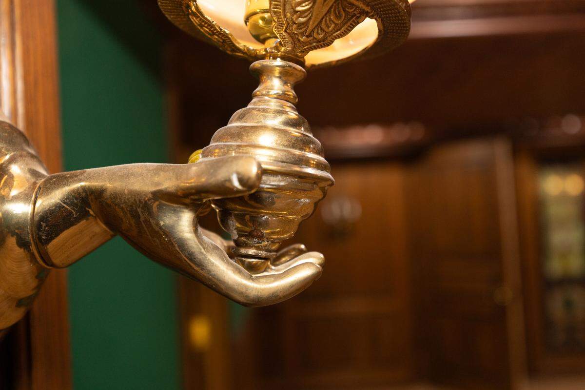 Elegant wall sconces provide moody lighting in the bar room.