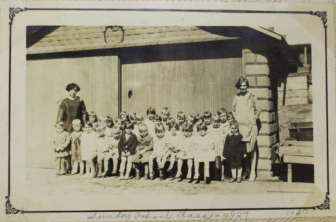 Children pose with teachers at St. Peter Evangelical United Church of Christ in Granite City in 1927. The church is closing in August after 118 years.