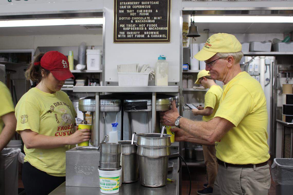 Co-owner Travis Dillon, right, and employee Lauren Lindner make concretes at the Ted Drewes location on Chippewa. The treats are like milkshakes, except they are so thick, you can turn them upside-down and they won't spill.