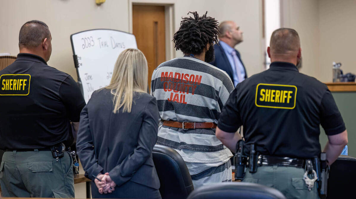 Zachary Capers, in jail uniform, stands to face a Madison County Circuit Court judge at a hearing Tuesday, surrounded by sheriff’s deputies and Delani Hemmer, one of his public defenders. He pleaded guilty but mentally ill to first-degree murder in the stabbing deaths of Edwardsville residents Lois and Michael Ladd.