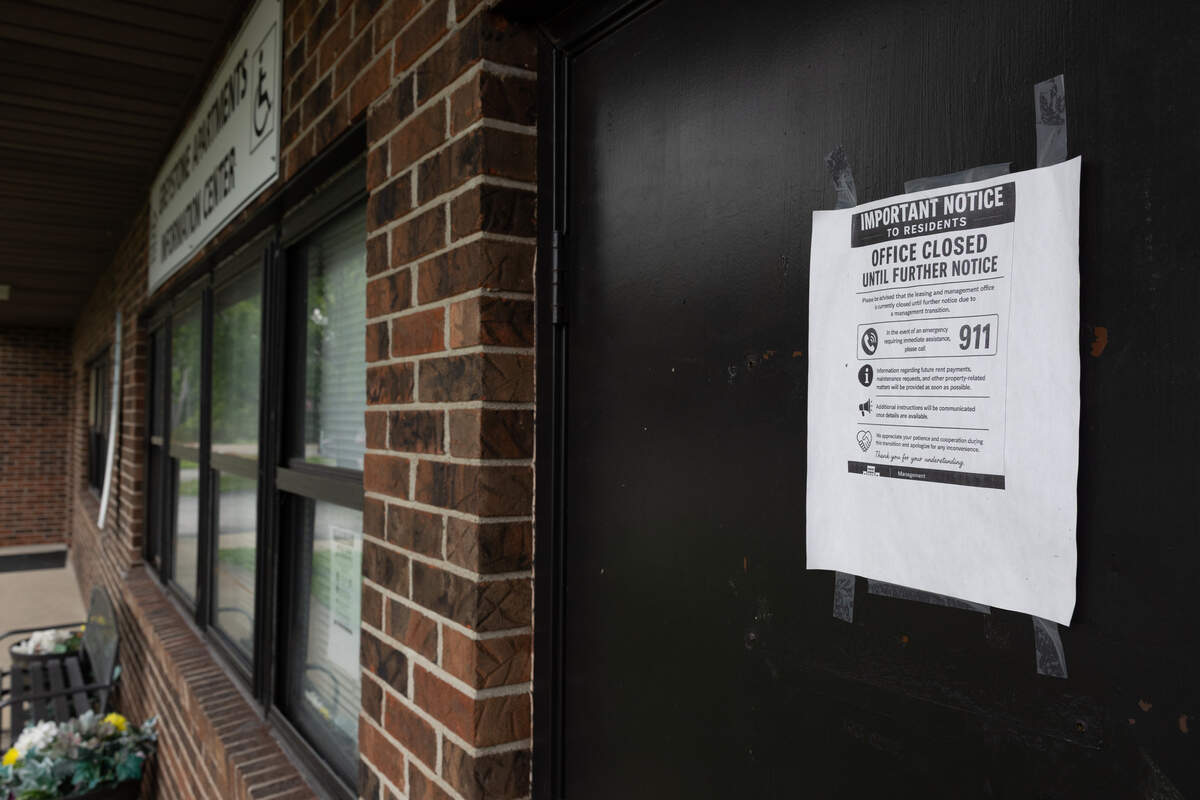 A sign on the padlocked outside door of the management office of the Greystone apartment complex in Cahokia Heights on June 25, declaring the building to be closed until further notice.