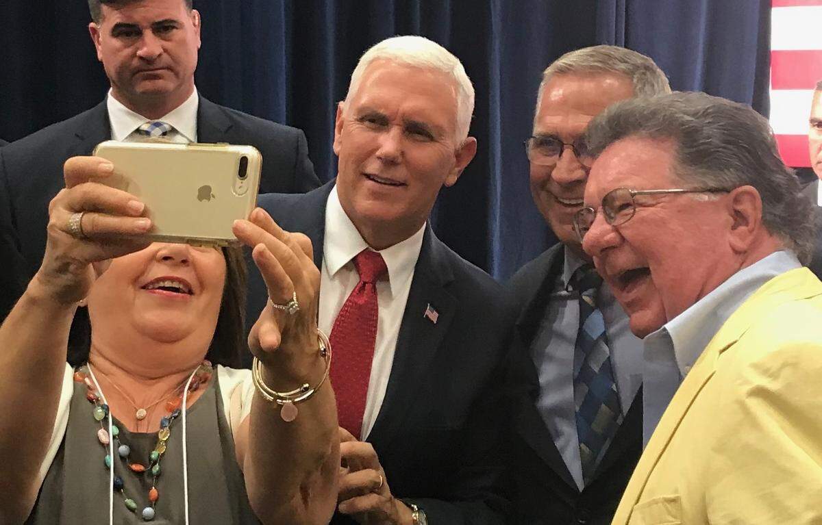 Joni Roy takes a selfie with, from left, Vice President Mike Pence, Congressman Mike Bost and her husband, Norman. Pence was in O’Fallon on Thursday for a fundraiser for Bost.