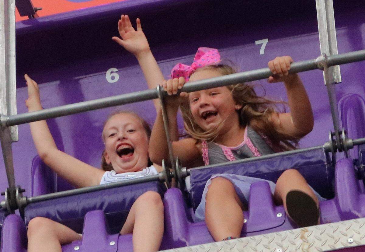 Kara Littlefield, left, and Violet Hallowell, right, laugh during a ride at the 2017 St. Jacob Homecoming Family Night.