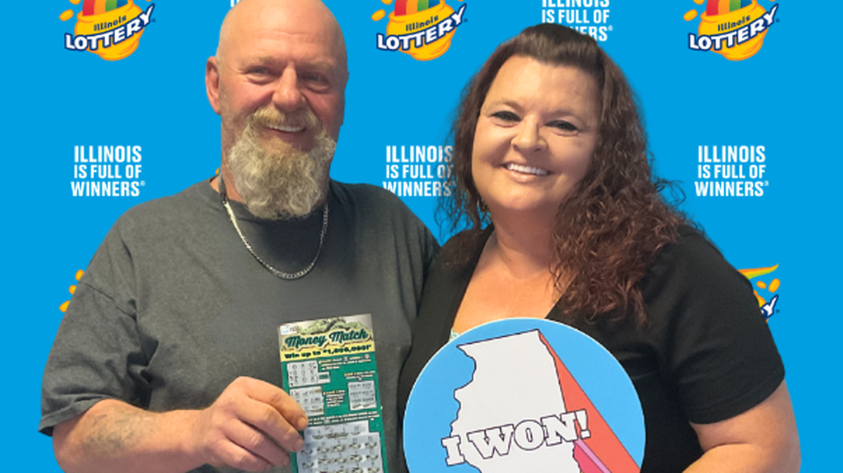 Cynthia, who wishes to keep her last name private, pose for a photograph with her husband after winning $1 million on a scratch-off ticket. 