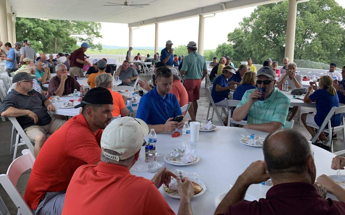 Participants in the PEG Can Help Benefit Golf Scramble gather for a meal on June 20 in a pavilion at Oak Valley Golf Course & Resort in Pevely, Missouri.