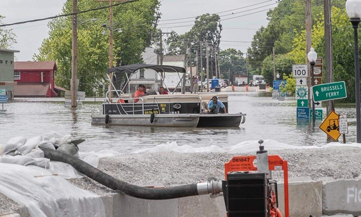 A pontoon boat travels above Main Street in Grafton, Illinois.