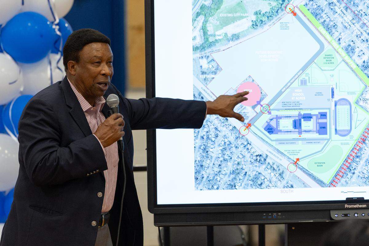 Ed Hightower shows a blueprint for the new Cahokia High School during a public meeting at the current high school in Cahokia Heights, Ill., on May 8, 2024.