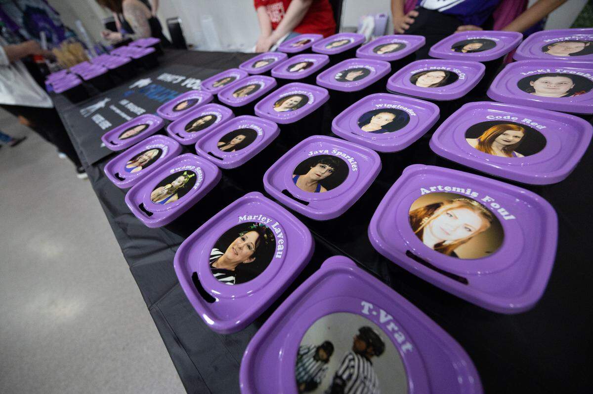 Faces of Confluence Crush players are posted on the outside of bins, making a game of choosing one’s favorite player.