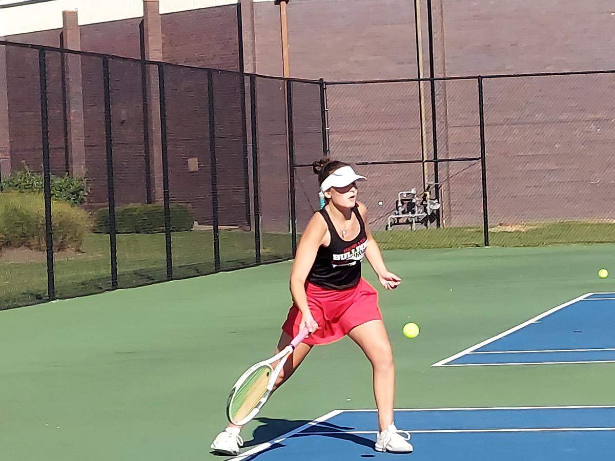 Highland’s Sophia Fleming sets to return a shot during her No. 1 singles match against Waterloo on Monday, Sept. 12, at Highland High School. Waterloo ultimately prevailed 6-3.