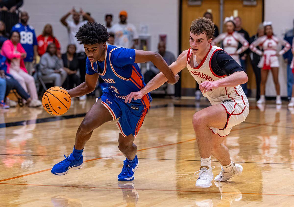 East St. Louis junior Phillip Jones dribbles past Centralia’s Devin Meier during the Flyers’ win in the Waterloo Class 3A Sectional championship game Friday.