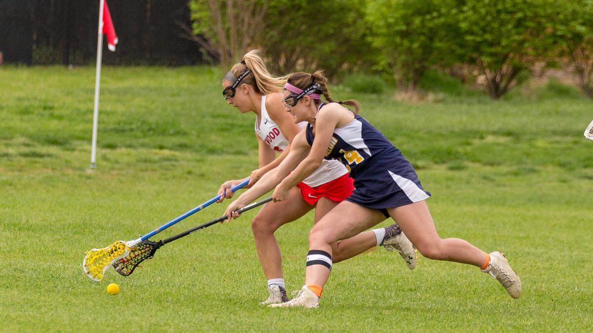 Maddie Dalonzo (14) fights for a ground ball against Kirkwood.