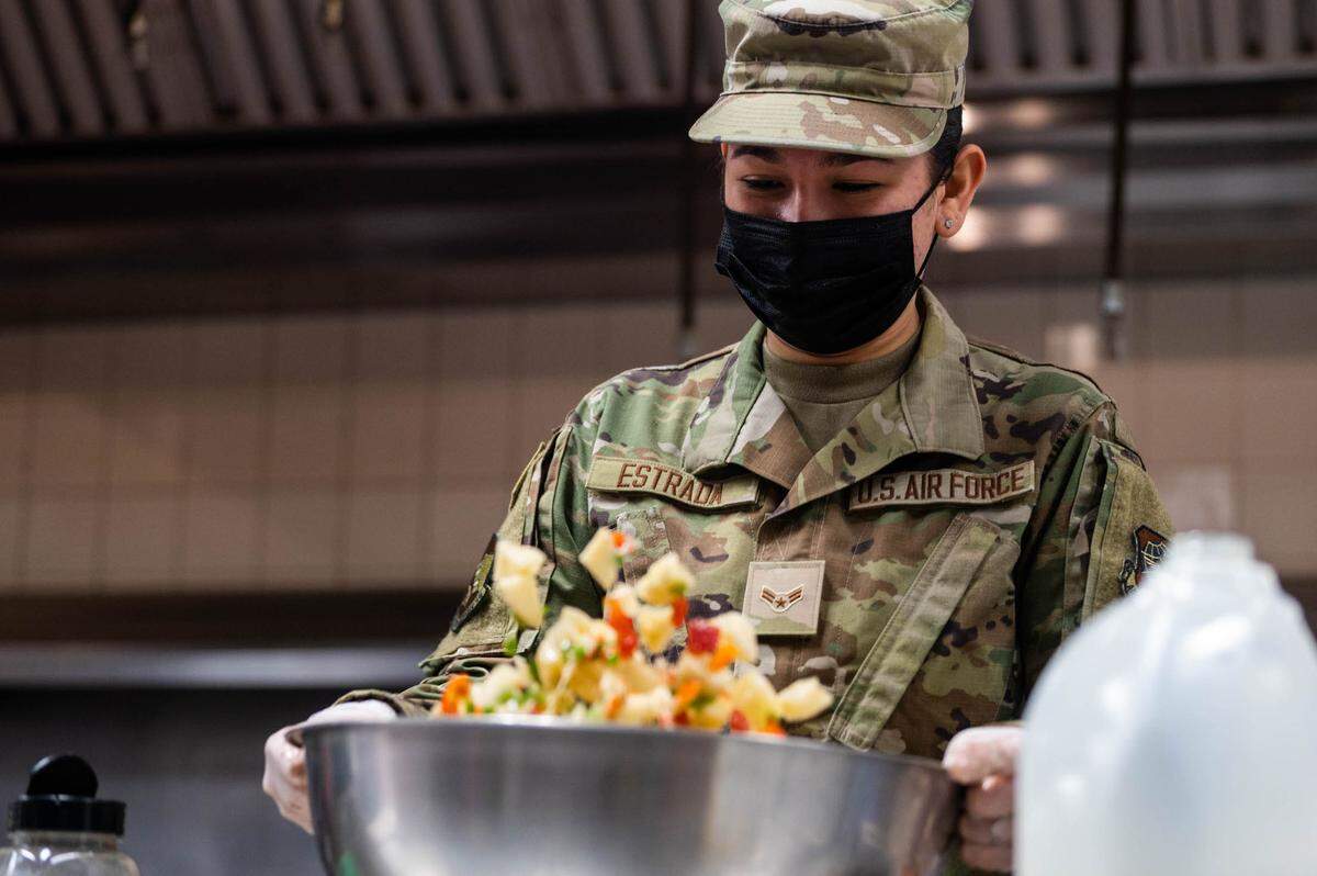 U.S. Air Force Airman 1st Class Julia Estrada, 375th Force Support Squadron food service apprentice, prepares food at the Nightingale Dining Facility on Scott Air Force Base. Each Airman and civilian working in the facility is trained in the proper procedures to cook food, follow recipe cards and maintain production logs.