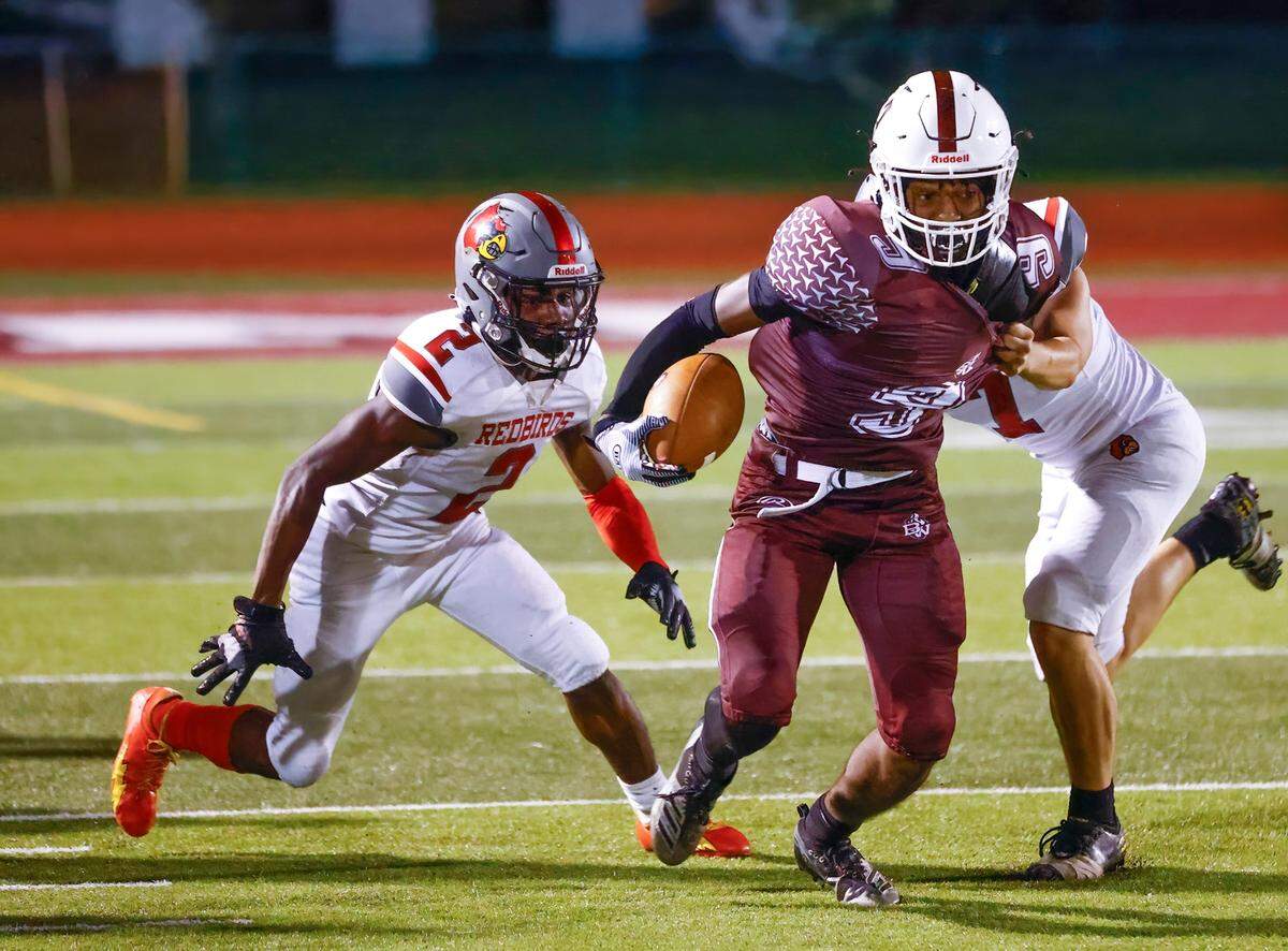 Belleville West’s DJ Cross runs the ball against Alton during a Southwestern Conference game Friday, Sept. 16. The Maroons ultimately lost to the Redbirds 28-7.