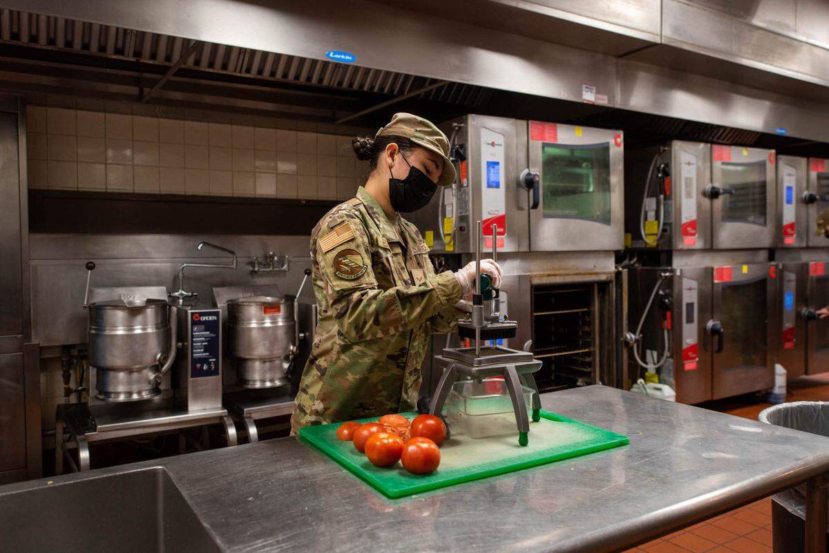U.S. Air Force Airman 1st Class Julia Estrada, 375th Force Support Squadron food service apprentice, slices tomatoes at the Nightingale Dining Facility on Scott Air Force Base. A few of Team Scott’s distinguished Airmen were selected to compete in The Culinary Challenge later this year.