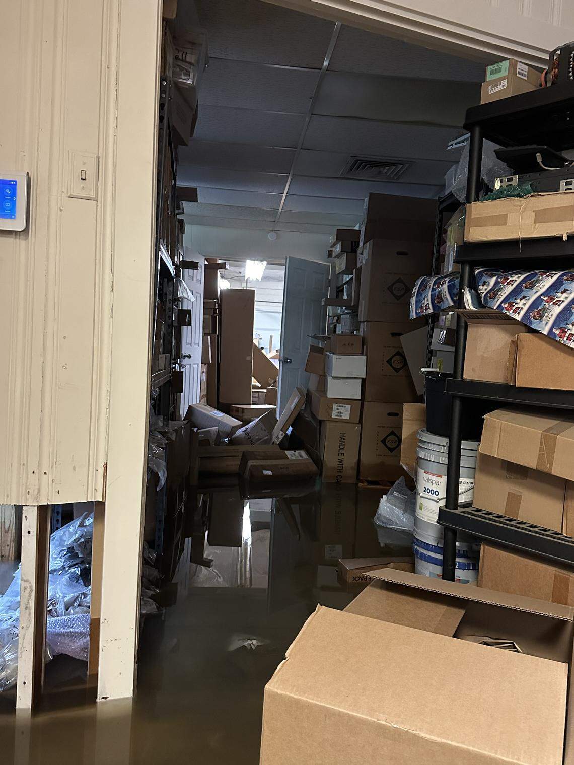 Water submerges the backroom of NEC Technology Repairs in Belleville, Ill., on July 16, 2024. Owner Dorian LeRoy said this is not the first time the business has flooded. It has flooded three to four times since the business moved into the property three years ago, with the last flood requiring $25,000 in repairs.