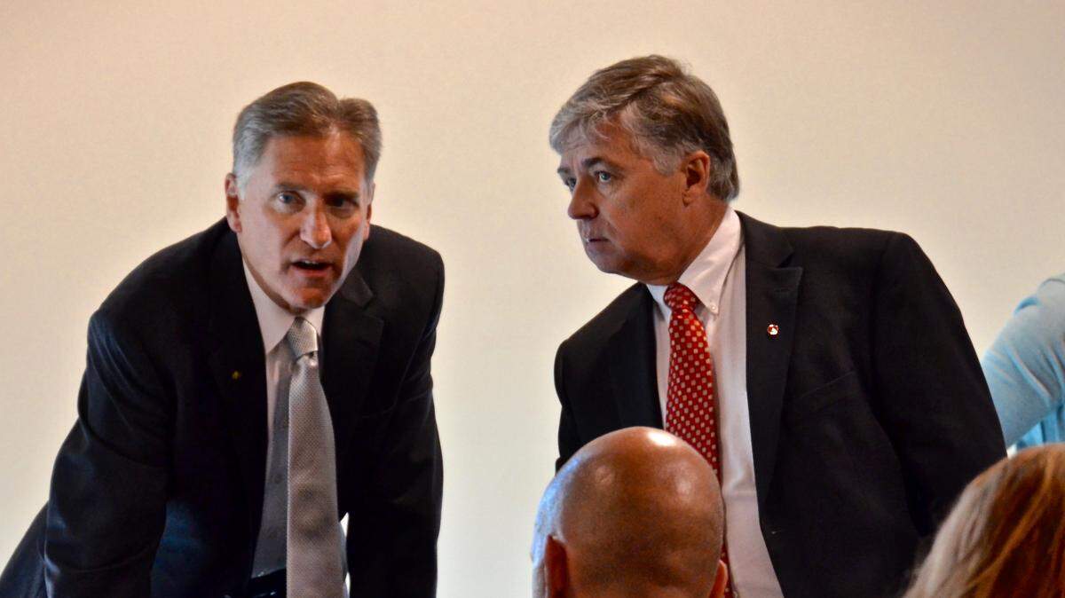Southern Illinois University President Randy Dunn confers with SIUE Chancellor Randy Pembrook in this file photo from a June trustees meeting. Dunn’s severance agreement was approved Monday by the board, ending a controversial tenure.