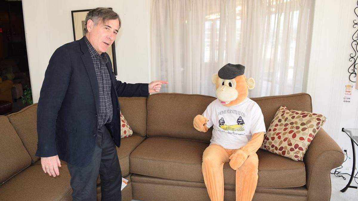 Ron Fredman of Home Furniture LLC with the company's mascot. The Collinsville store expects to close later this year.