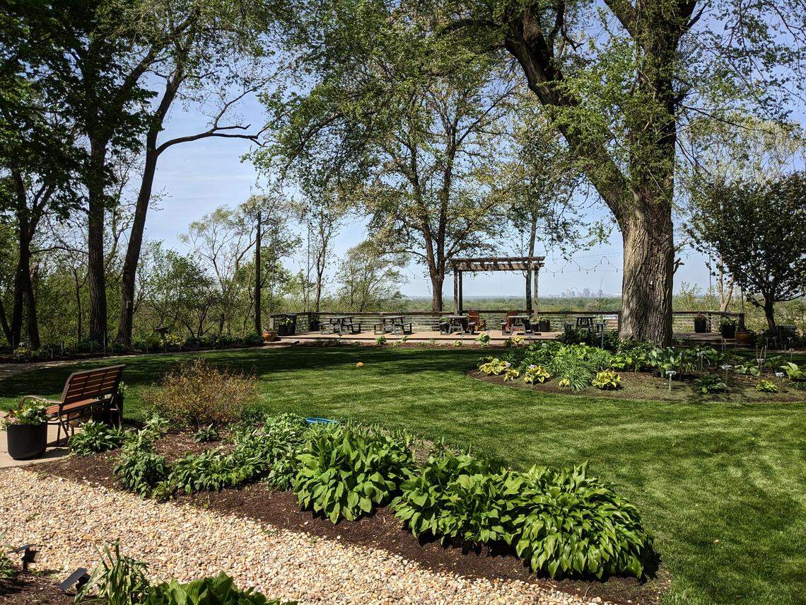 View of the garden and patio at Hostas on the Bluff with the St. Louis skyline just visible in the background