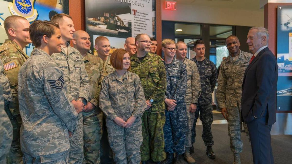 Gen. Darren W. McDew, U.S. Transportation Command commander, looks on as Secretary of Defense James Mattis addresses base personnel at Scott on Feb. 21. Mattis met with USTRANSCOM leaders and held an all-hands call with Team Scott during his visit to the base.
