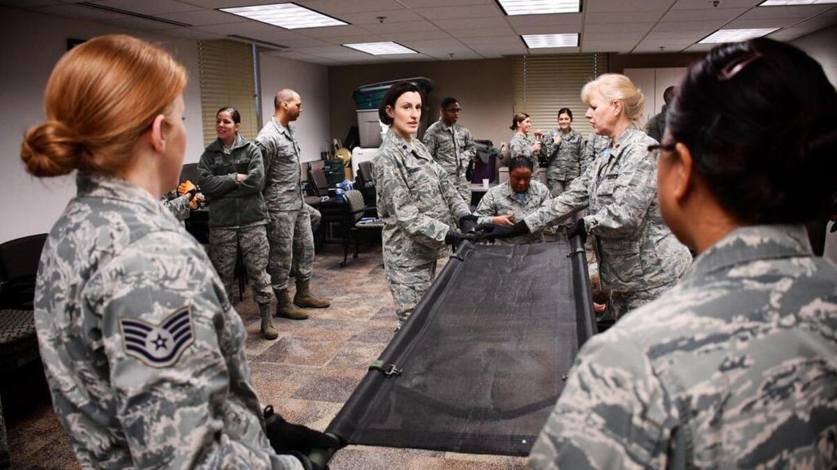 Airmen are all business as self aid and buddy care classes with litter carries takes place. Here, a group of 932nd Aeromedical Staging Squadron members practice proper lifting techniques to properly move up with their litter, and potentially load any type of vehicle for patient movement. The 932nd Airlift Wing worked improving and refining skills at the unit during the Unit Training Assembly weekend at Scott Air Force Base.