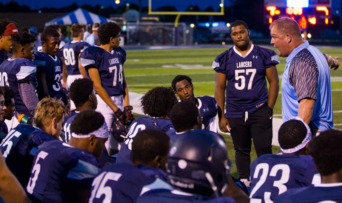 Belleville East assistant coach Eric Hawthorne talks to his squad in the first half.
