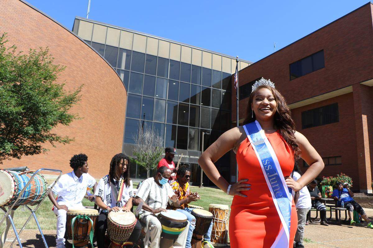 Grace Glass, 17, poses in front of the East St. Louis Community Performance Ensemble during Juneteenth events in East St. Louis on Saturday. The incoming high school senior from Swansea was named Miss Juneteenth Illinois.