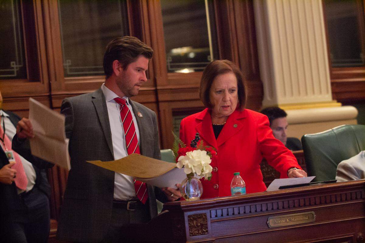 State Rep. Ryan Spain, R-Peoria, and Norrine Hammond, R-Macomb, converse on the House floor during debate of the state budget.